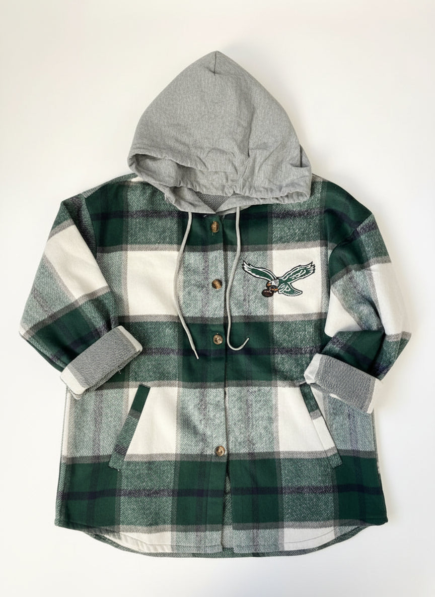 Green and gray plaid shirt with embroidered design on a white background